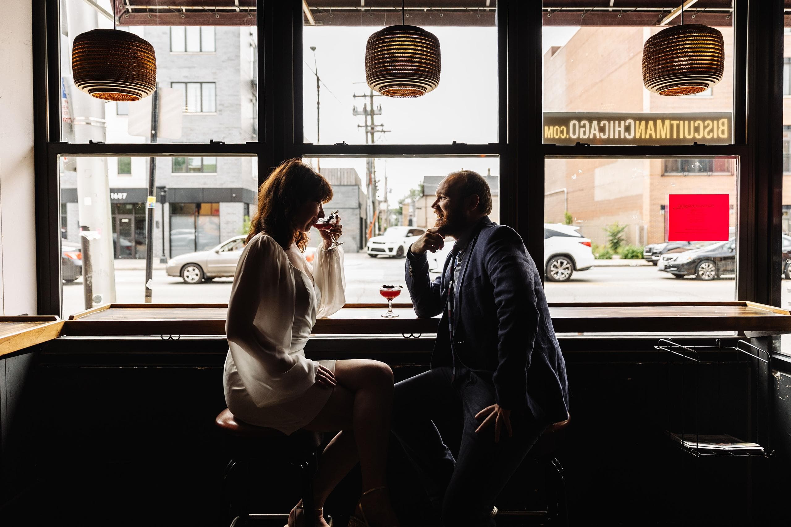 Engagement photo of the couple enjoying drinks at the Long Room